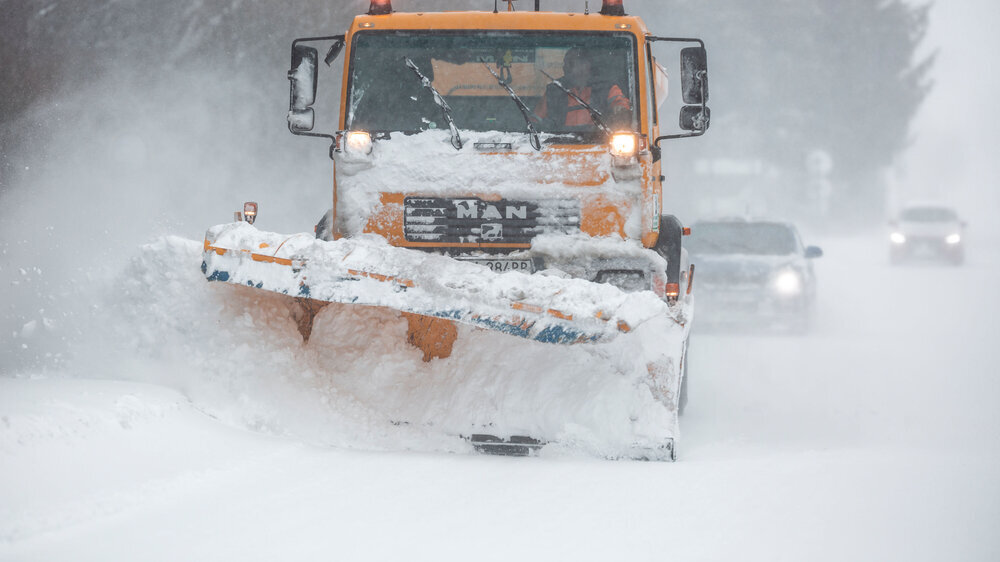 Liptov, Slovakia - JANUARY 30, 2022. The snow plow clears the way for the cars behind it.