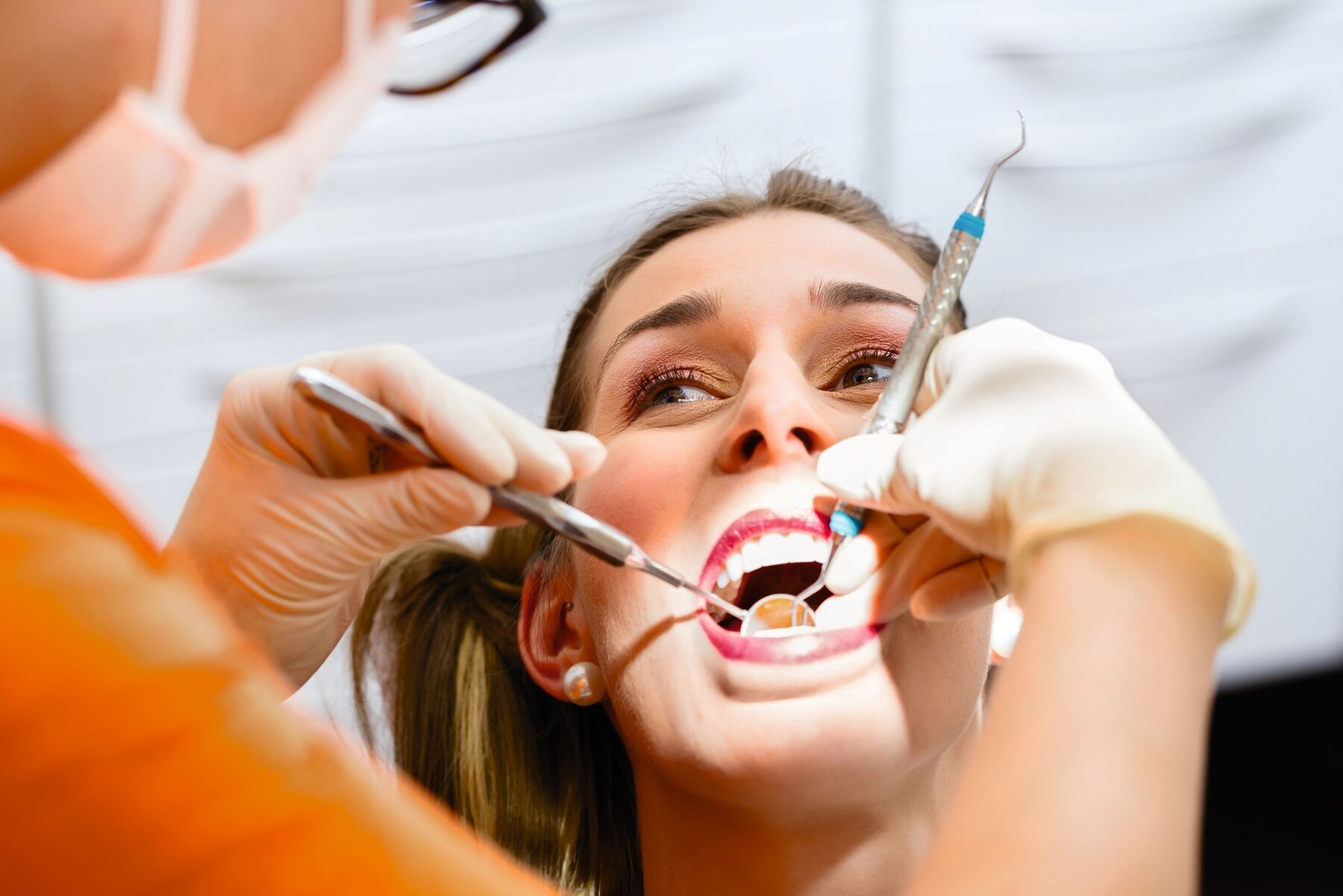 Patient having deep dental tooth cleaning at dentist Patient having deep dental tooth cleaning at dentist
