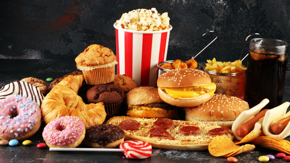 Unhealthy products. food bad for figure, skin, heart and teeth. Assortment of fast carbohydrates food with fries and cola