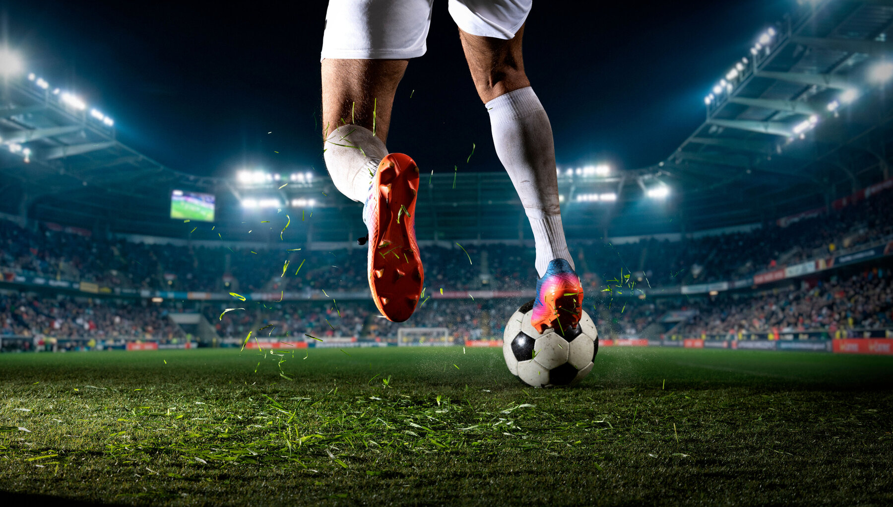 Soccer player stepping on ball during night match in stadium. Concept of ball control, tactical pause, sport footwear advertising, match promo, and team strategy visuals. Soccer player stepping on ball during night match in stadium. Concept of ball control, tactical pause, sport footwear advertising, match promo, and team strategy visuals.