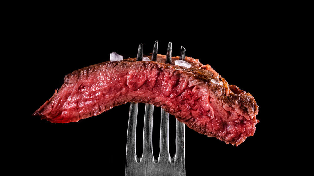 Beef meat rare on fork black background Beef meat rare on fork black background