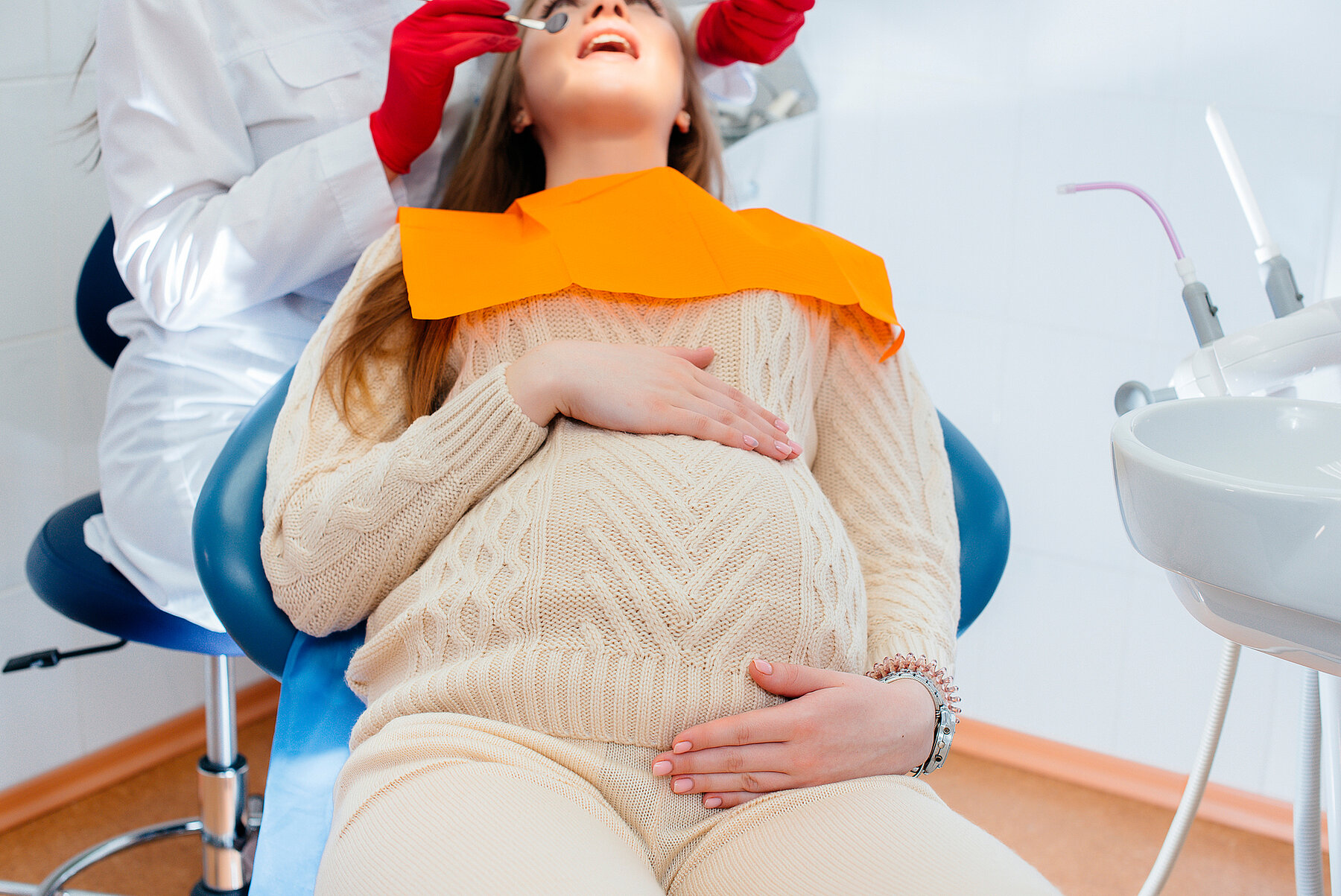 A professional dentist treats and examines the oral cavity of a pregnant girl in a modern dental office. Dentistry A professional dentist treats and examines the oral cavity of a pregnant girl in a modern dental office. Dentistry